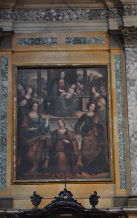 Madonna in trono col Bambino, S. Giovannino, le Sante Lucia, Agata, Caterina, Apollonia, Elena e Monica con Sant'Agostino e il committente